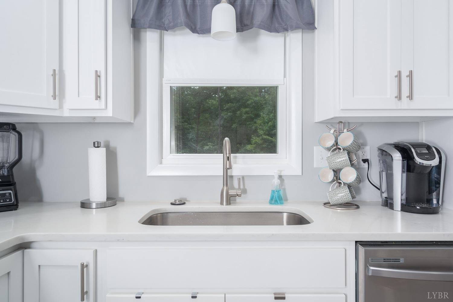 905 Gap Bridge Road Moneta, VA 24121 - Photo 14 of 48 a kitchen with a sink and cabinets