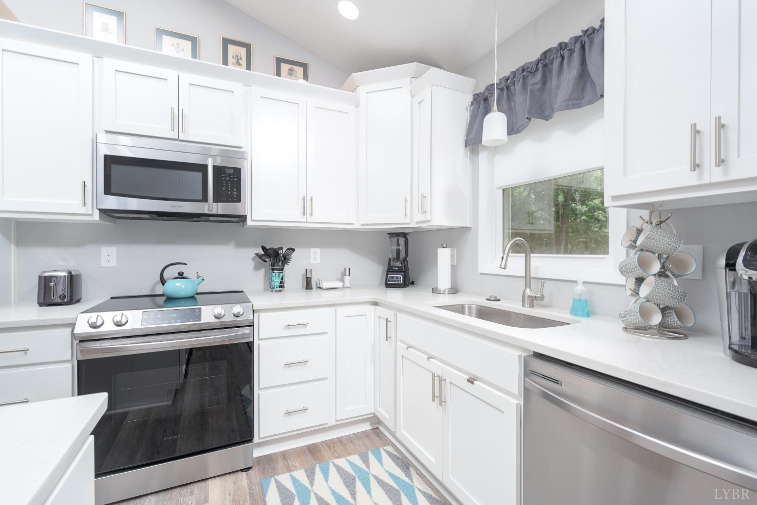 905 Gap Bridge Road Moneta, VA 24121 - Photo 15 of 48 a kitchen with cabinets stainless steel appliances a sink a window and cabinets