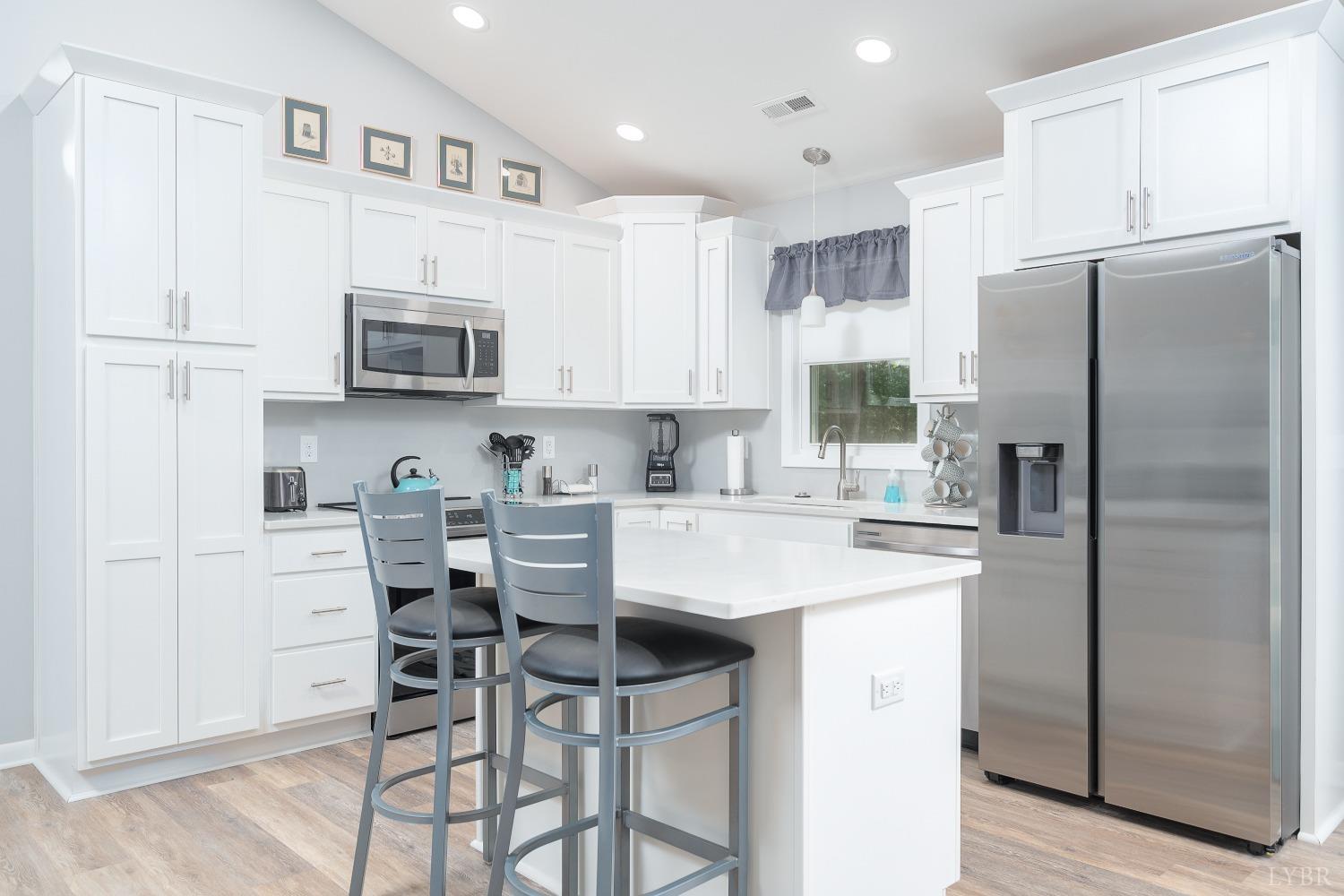 905 Gap Bridge Road Moneta, VA 24121 - Photo 16 of 48 a kitchen with stainless steel appliances a refrigerator stove microwave and cabinets