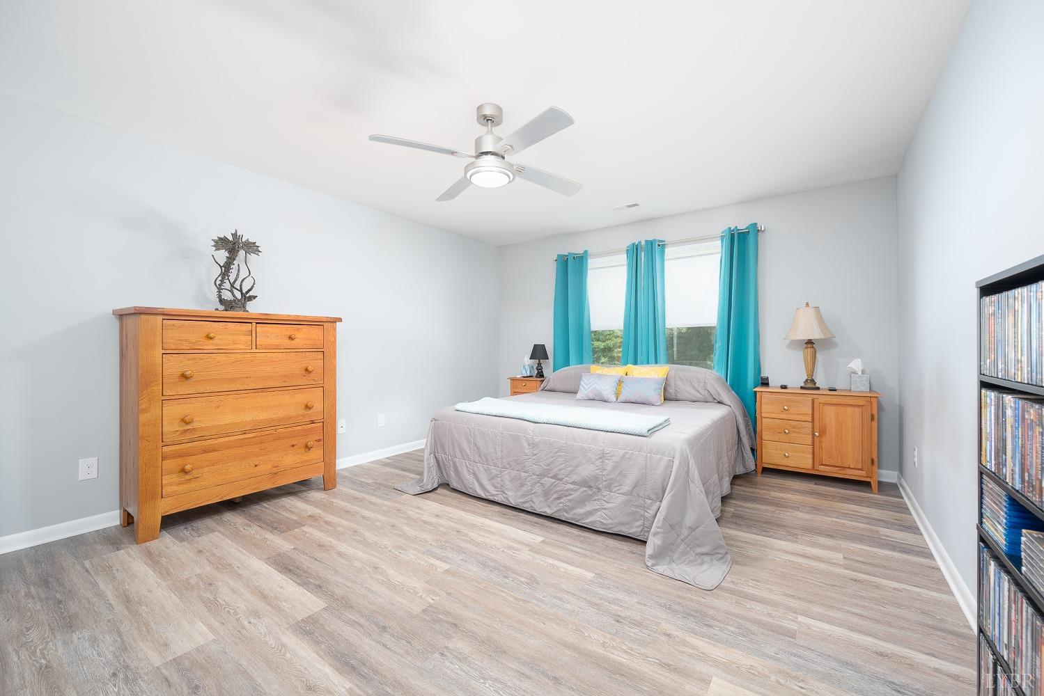 905 Gap Bridge Road Moneta, VA 24121 - Photo 19 of 48 a spacious bedroom with a bed and a dresser