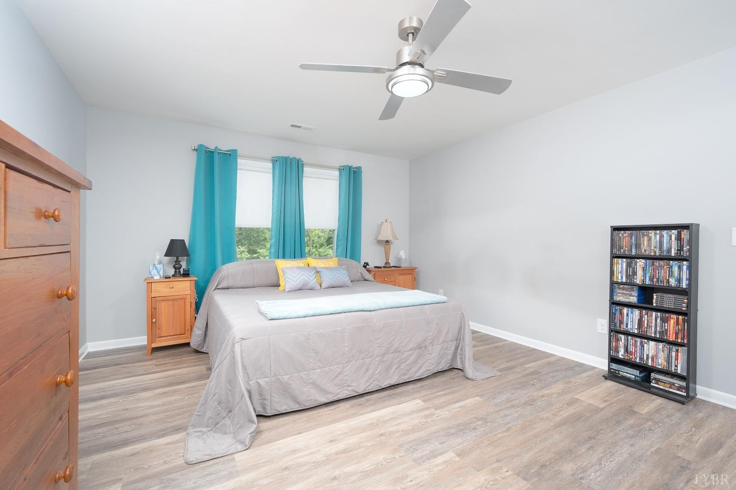 905 Gap Bridge Road Moneta, VA 24121 - Photo 20 of 48 a bed room with a bed and a book shelf