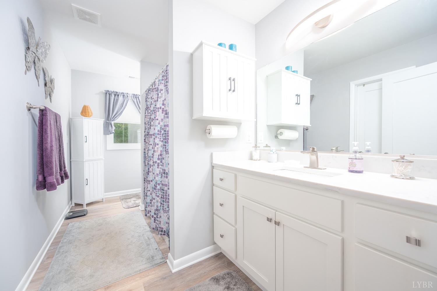 905 Gap Bridge Road Moneta, VA 24121 - Photo 22 of 48 a bathroom with a double vanity sink mirror and shower