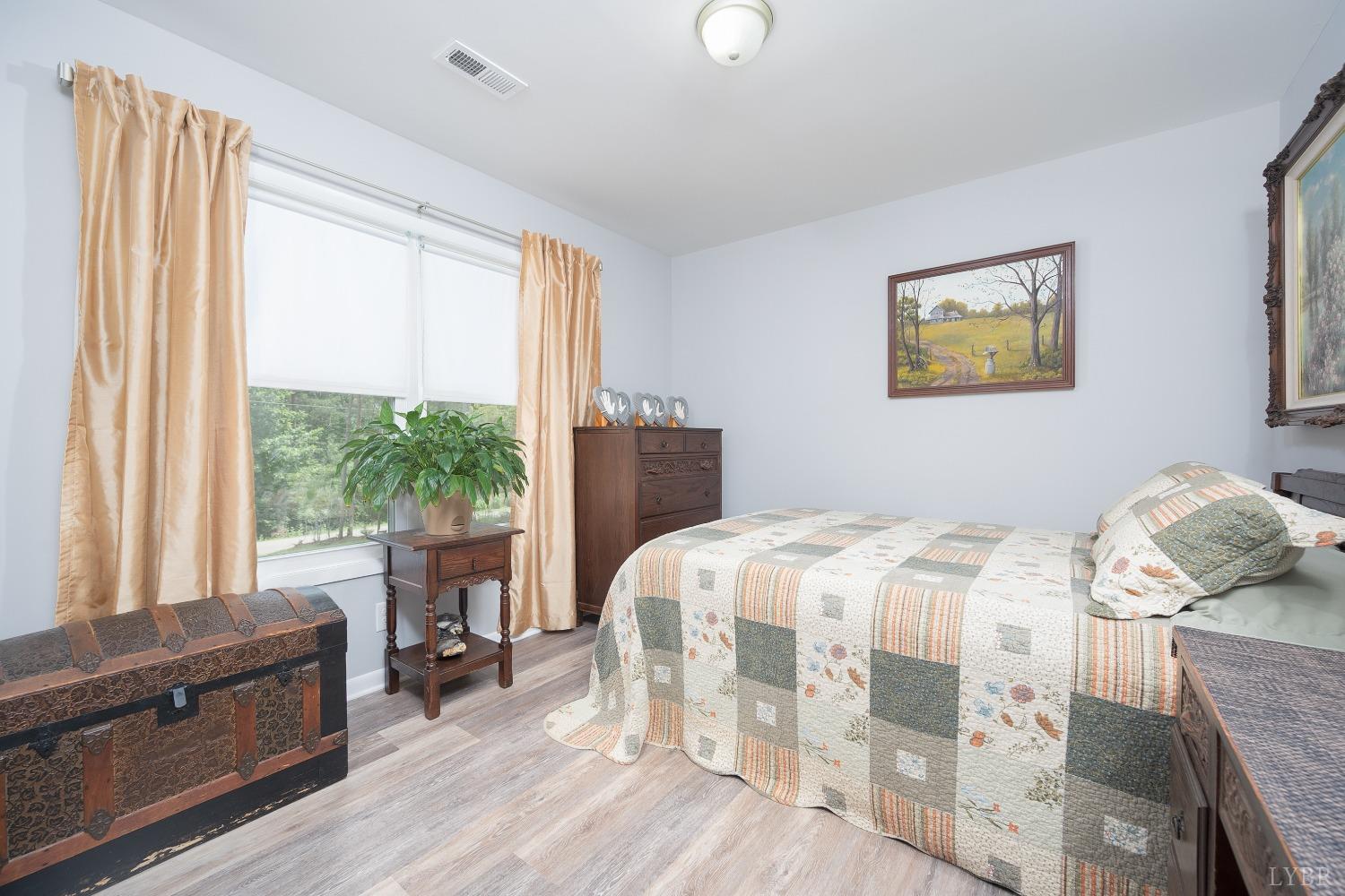 905 Gap Bridge Road Moneta, VA 24121 - Photo 25 of 48 a bedroom with a bed and wooden floor