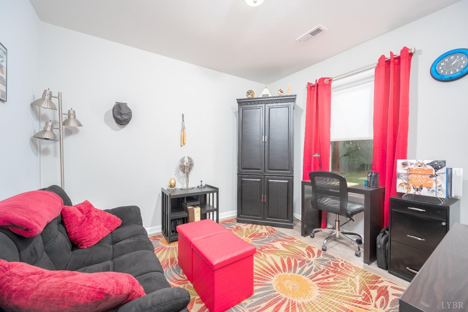 905 Gap Bridge Road Moneta, VA 24121 - Photo 29 of 48 a bedroom with bed and a chandelier