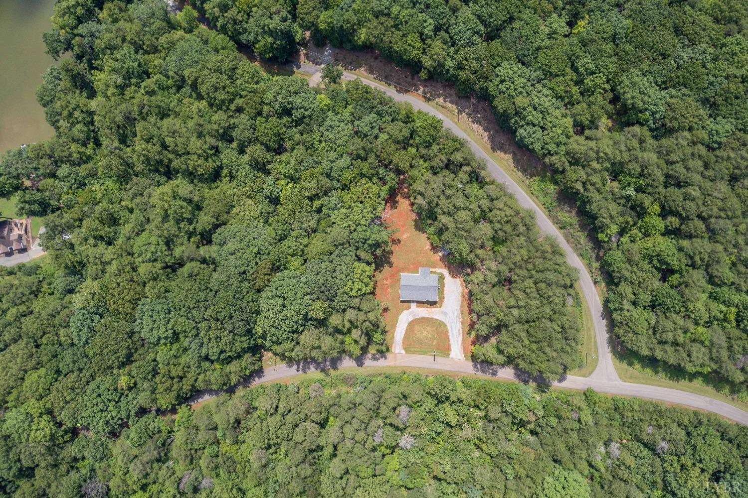 905 Gap Bridge Road Moneta, VA 24121 - Photo 47 of 48 an aerial view of a house with a yard and large trees