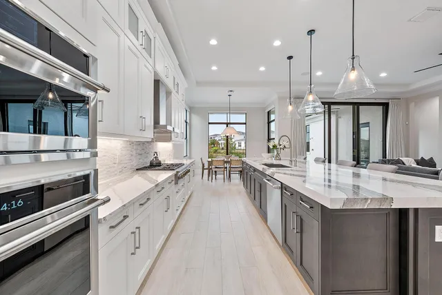a large kitchen with granite countertop lots of counter space and a sink