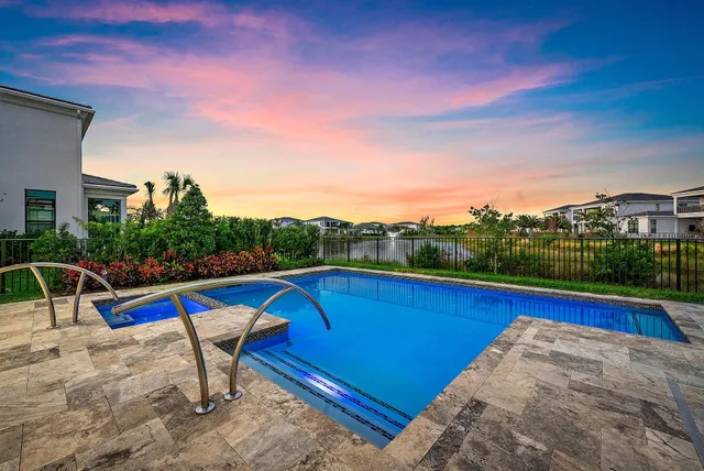 a view of a roof deck with a table and chairs with wooden floor and fence