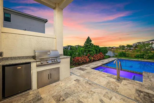 an aerial view of residential houses with outdoor space and swimming pool