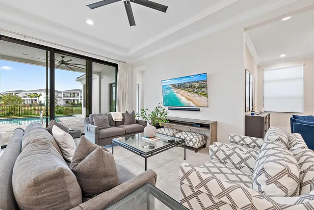 a bedroom with furniture and large windows