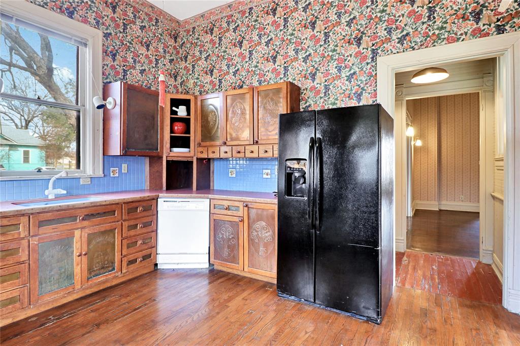 200 South Colorado Street Whitney, TX 76692 - Photo 13 of 38 a kitchen with stainless steel appliances granite countertop a refrigerator and a sink