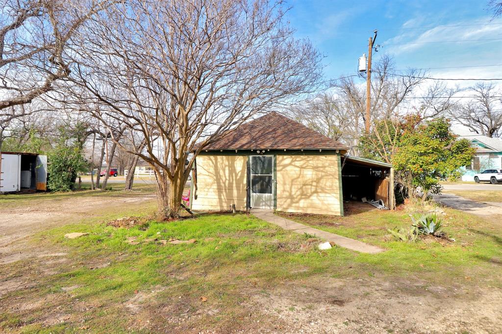 200 South Colorado Street Whitney, TX 76692 - Photo 27 of 38 a view of a house with a yard and garage