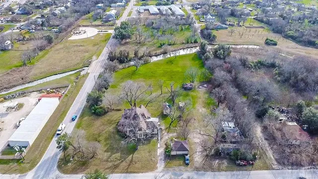 an empty room with wooden floor closet and windows