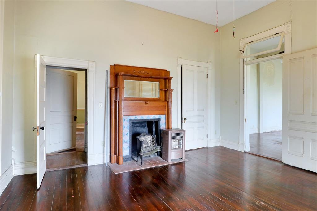 200 South Colorado Street Whitney, TX 76692 - Photo 5 of 38 a view of an empty room with wooden floor and a window