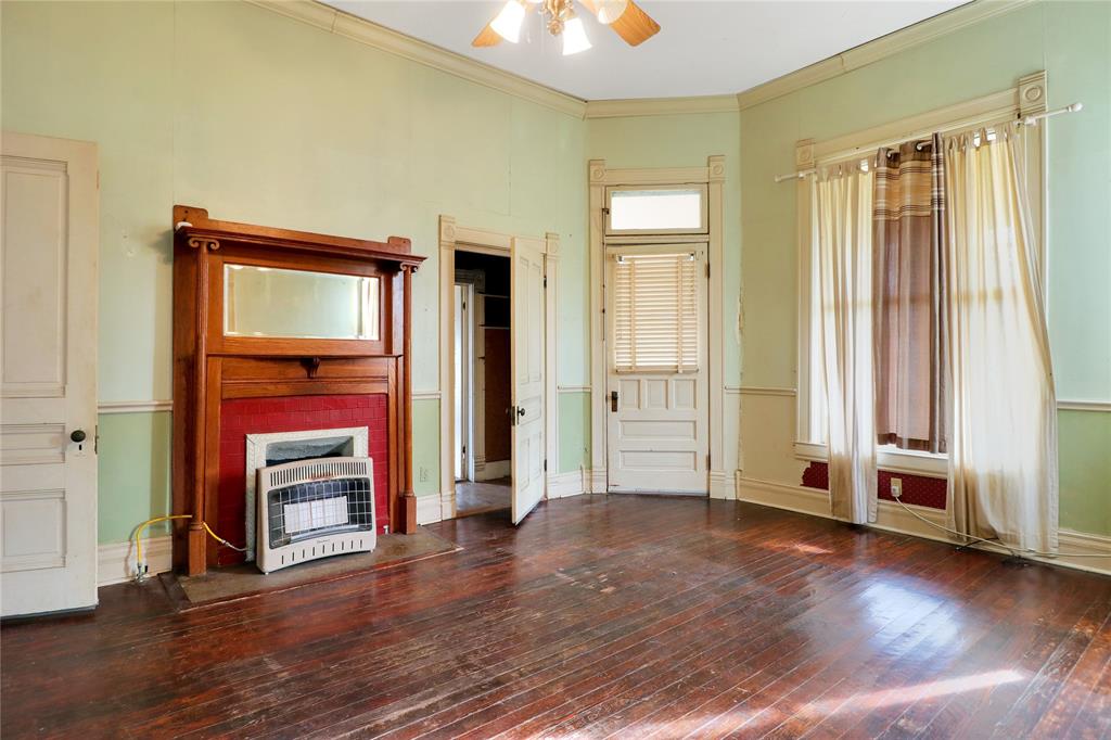 200 South Colorado Street Whitney, TX 76692 - Photo 6 of 38 an empty room with wooden floor closet and windows