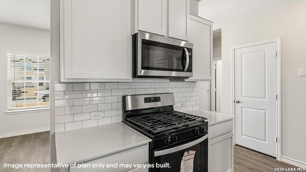 620 Fluted Shoals Cibolo, TX 78108 - Photo 13 of 44 a kitchen with cabinets and a stove top oven