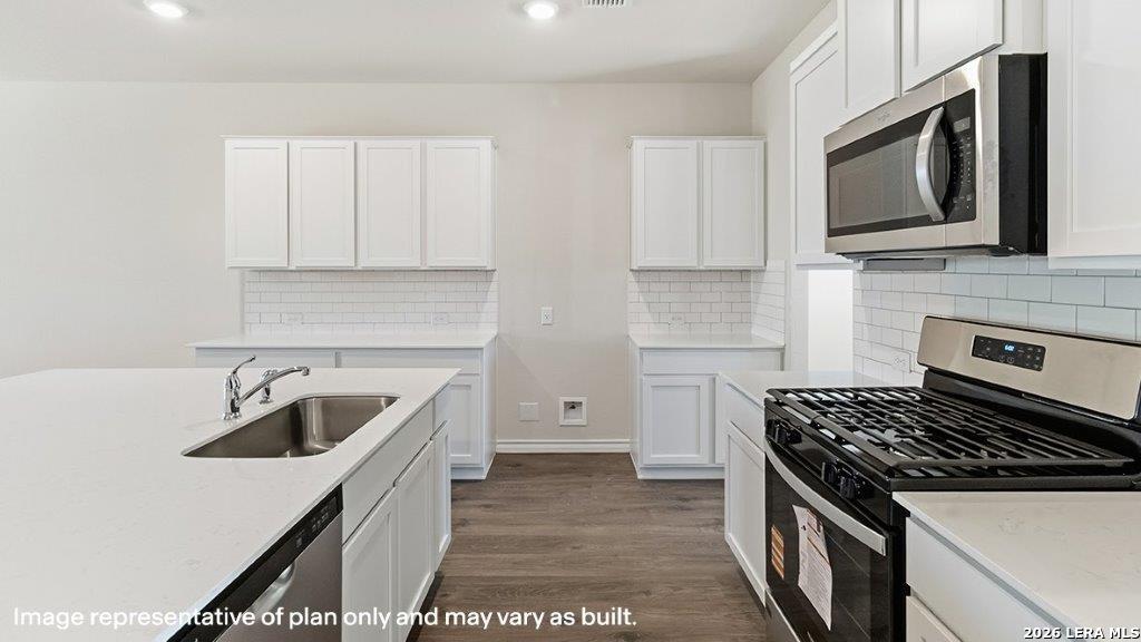 620 Fluted Shoals Cibolo, TX 78108 - Photo 14 of 44 a kitchen with stainless steel appliances granite countertop a sink stove microwave and refrigerator