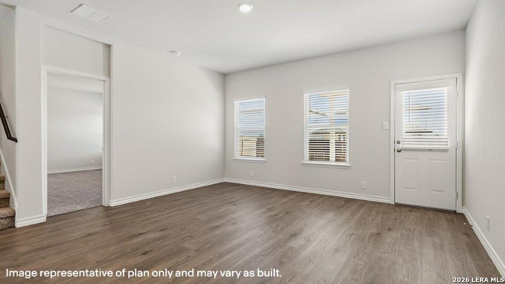 620 Fluted Shoals Cibolo, TX 78108 - Photo 5 of 44 an empty room with wooden floor and windows