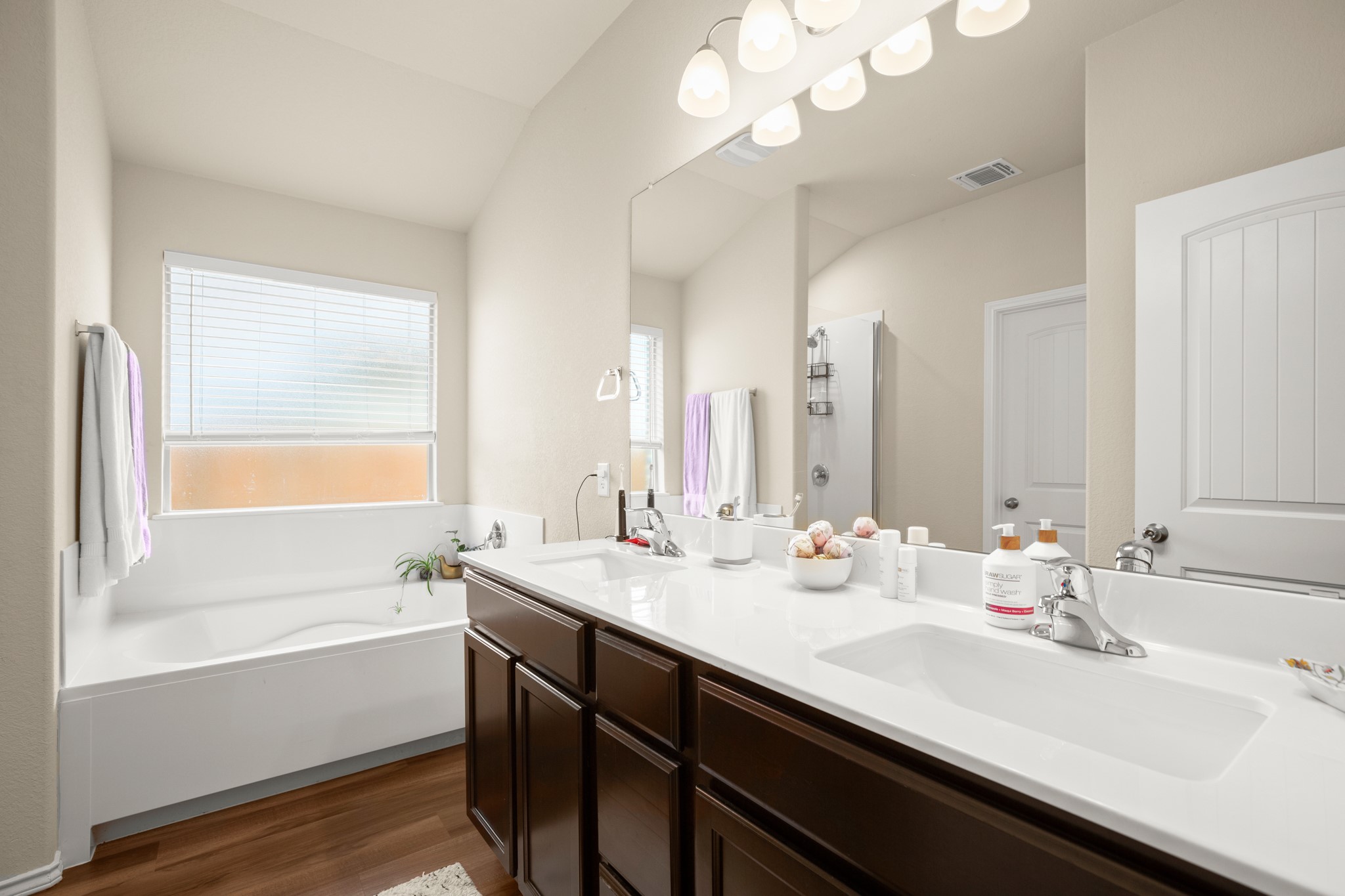 5526 Perdita Drive Belton, TX 76513 - Photo 14 of 26 Full bath with dark wood-style flooring, double vanity, a bath, and a stall shower