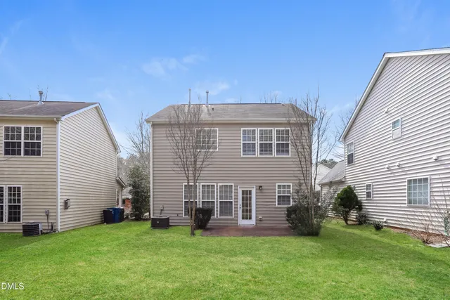 a view of a house with a yard and sitting area