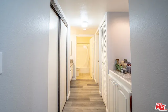 a view of a hallway with wooden floor and staircase