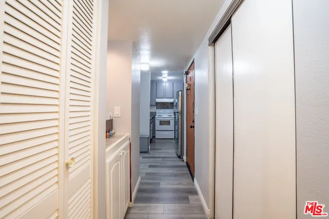 a view of a hallway with wooden floor