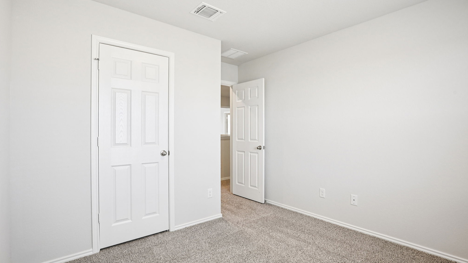 133 Wyatt Way Jarrell, TX 76537 - Photo 27 of 32 Bedroom featuring light gray wall paint, gray carpet flooring, white trim, and a white paneled door