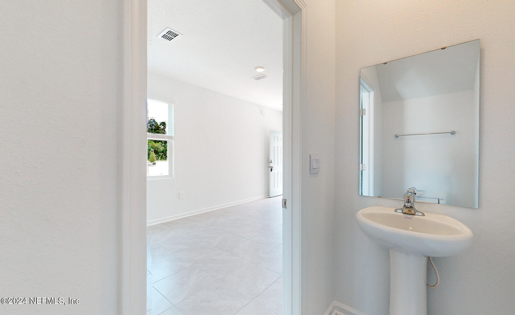 97 Hidden Mdws Road St. Augustine, FL 32095 - Photo 11 of 27 a bathroom with a sink and a mirror