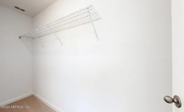 a bathroom with a sink shower and a mirror