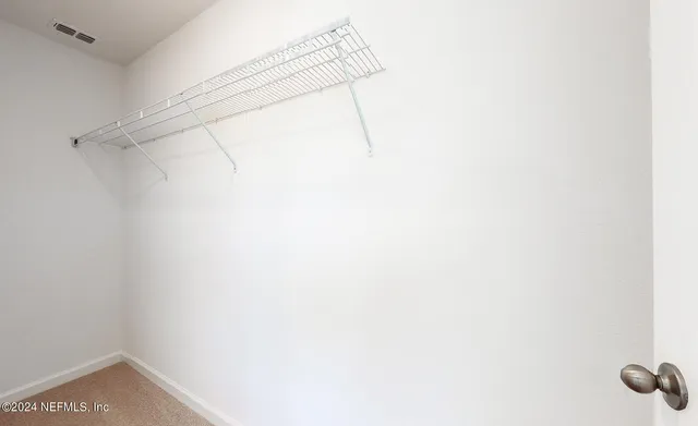 a bathroom with a sink shower and a mirror