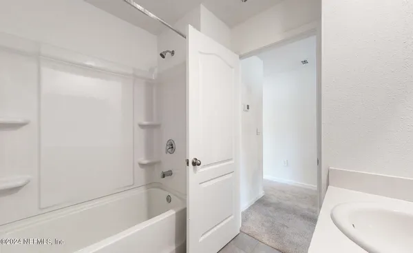 an empty room with windows and cabinet