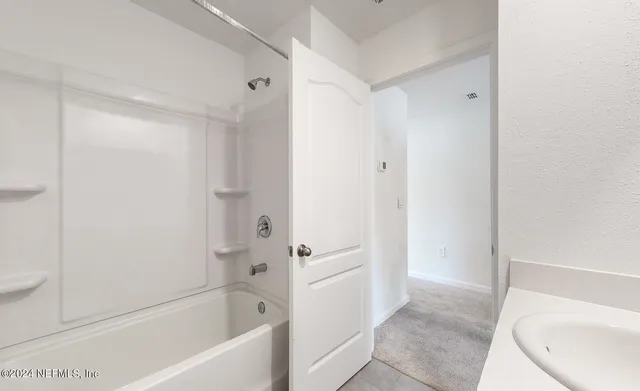 an empty room with windows and cabinet