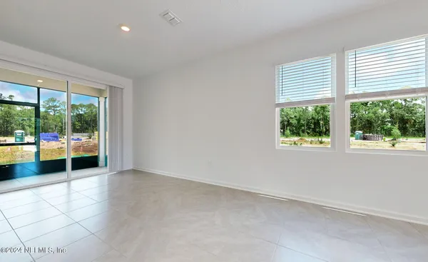 an empty room with an outdoor view and a window