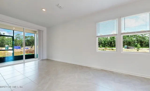 an empty room with an outdoor view and a window