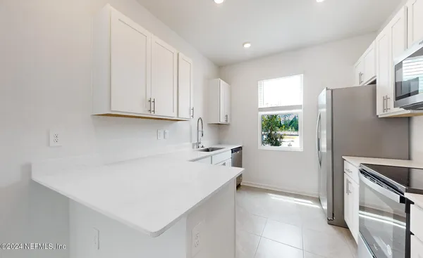 a kitchen with a sink a stove and refrigerator