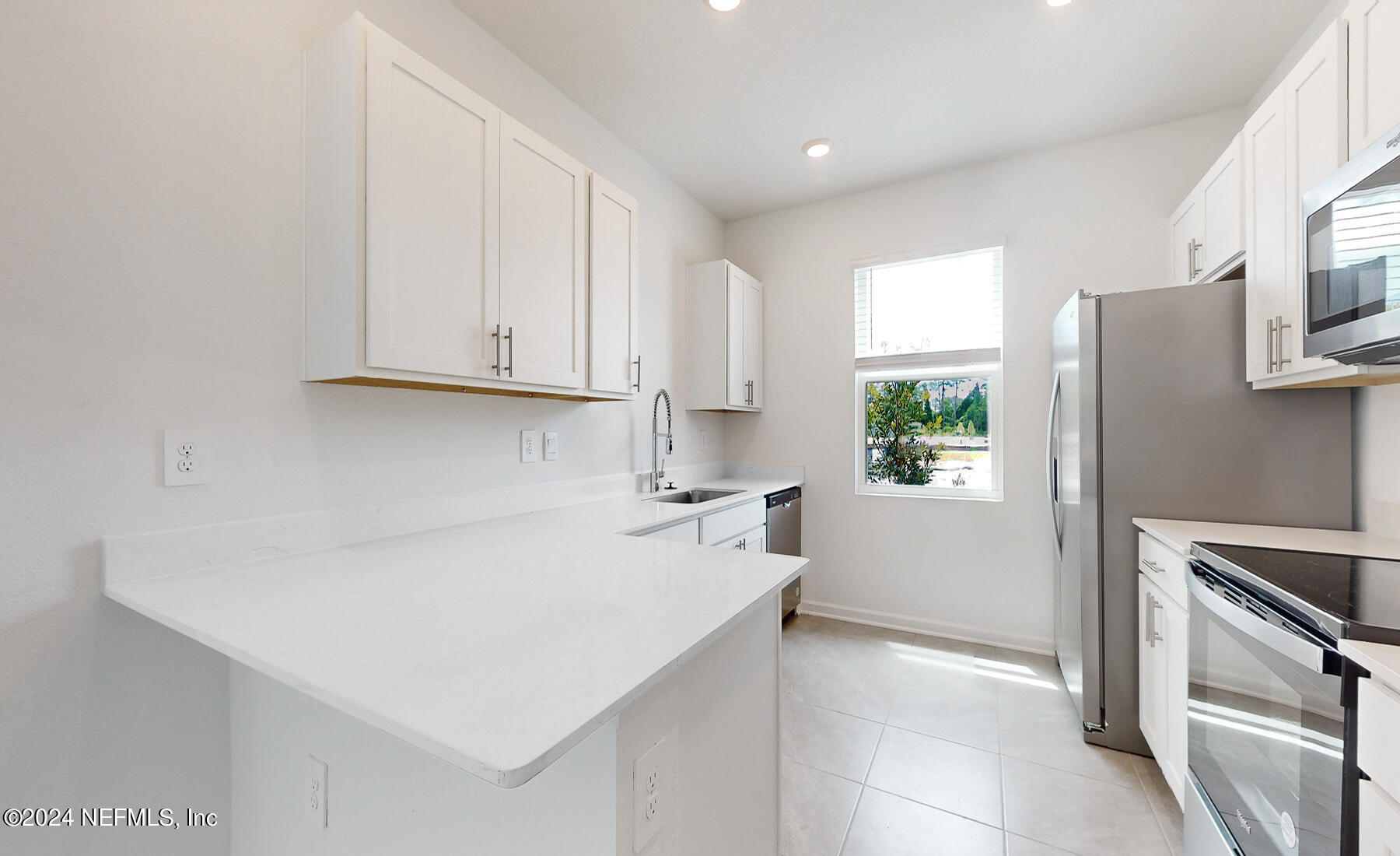 97 Hidden Mdws Road St. Augustine, FL 32095 - Photo 8 of 27 a kitchen with a sink a stove and refrigerator
