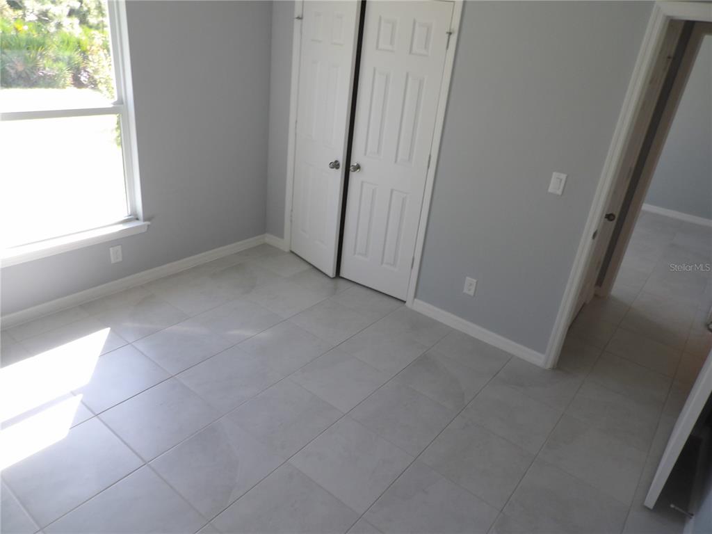 7653 Minardi Street North Port, FL 34291 - Photo 12 of 20 an empty room with windows