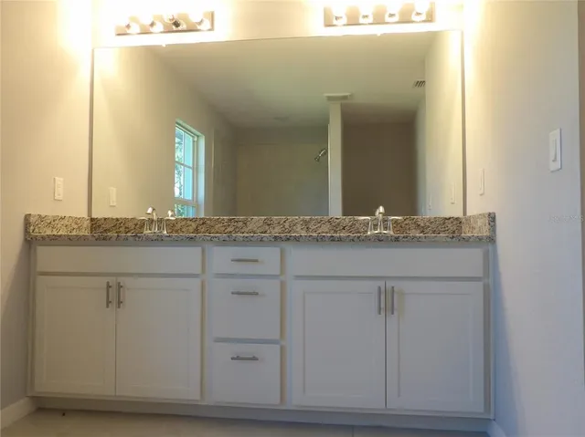 a bathroom with a sink and mirror