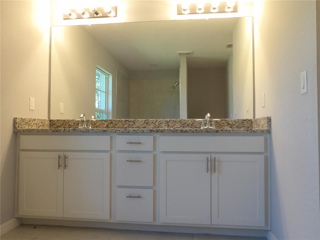 7653 Minardi Street North Port, FL 34291 - Photo 15 of 20 a bathroom with a sink and mirror