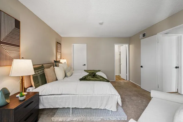 a bedroom with a bed and a lamp