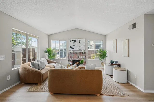 a living room with furniture and a fireplace