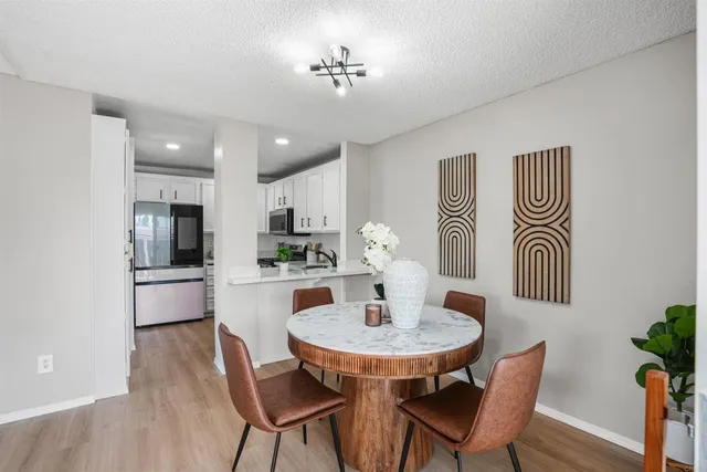 a kitchen with a table and chairs in it