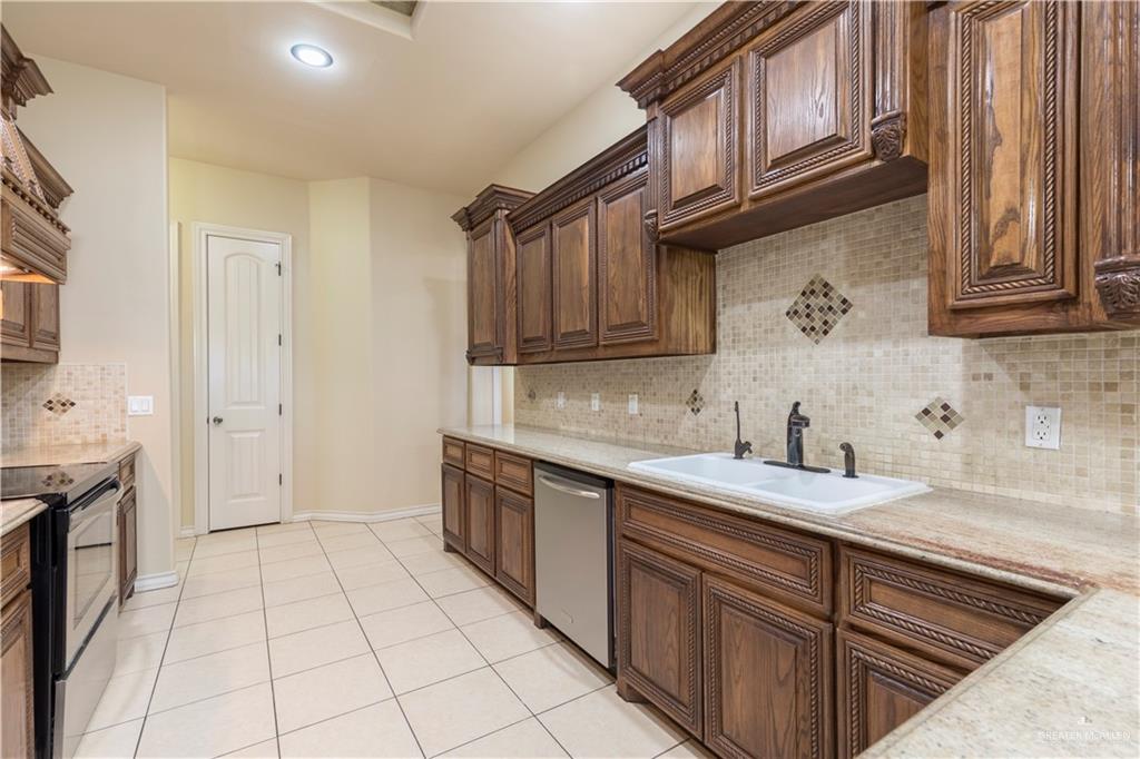 4212 Toronto Avenue McAllen, TX 78503 - Photo 3 of 15 a kitchen with a sink stove and cabinets