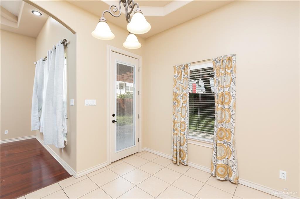 4212 Toronto Avenue McAllen, TX 78503 - Photo 5 of 15 a view of a hallway with wooden floor and chandelier