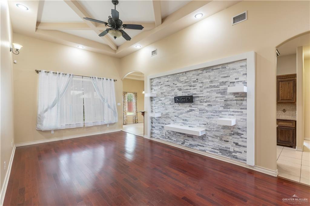 4212 Toronto Avenue McAllen, TX 78503 - Photo 6 of 15 a view of a livingroom with wooden floor a ceiling fan and windows