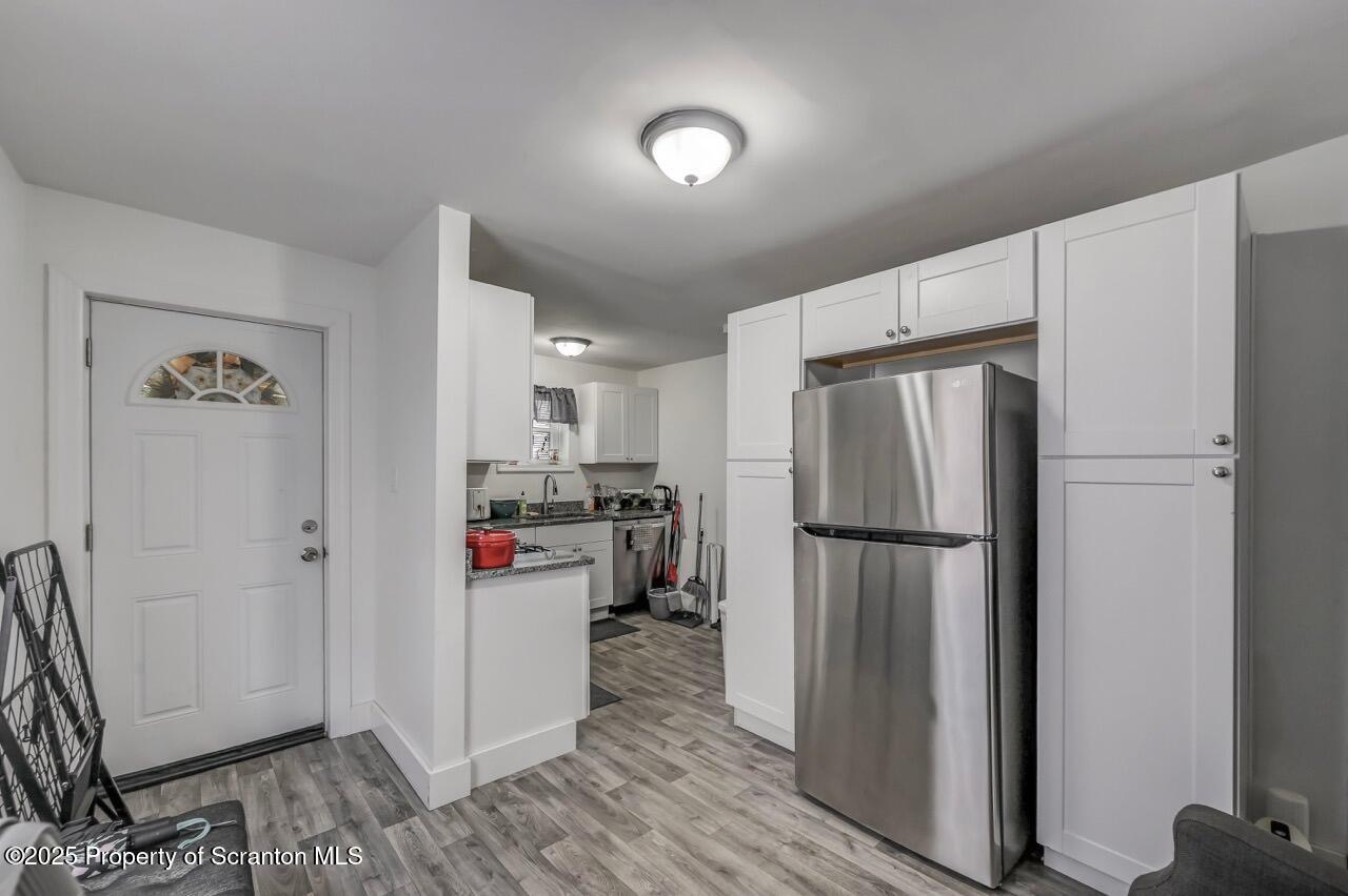 317-319 10th Avenue Scranton, PA 18504 - Photo 11 of 64 a kitchen with stainless steel appliances a refrigerator a sink cabinets and wooden floor