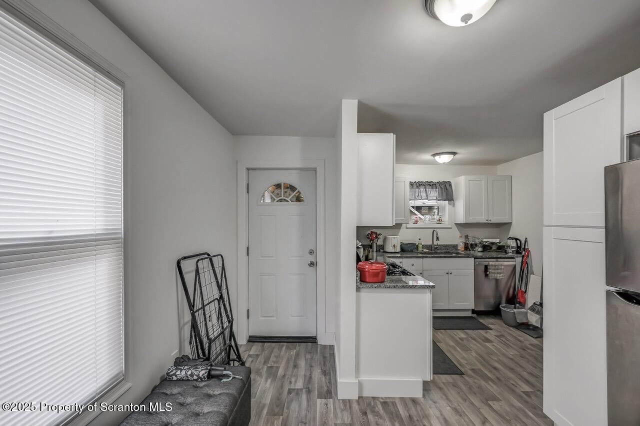 317-319 10th Avenue Scranton, PA 18504 - Photo 12 of 64 a kitchen that has a refrigerator and wooden floor