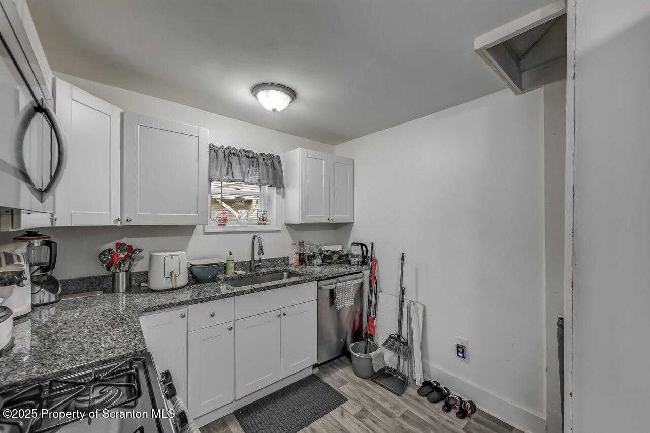 317-319 10th Avenue Scranton, PA 18504 - Photo 13 of 64 a kitchen with a sink cabinets and window