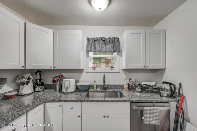 a kitchen with sink a stove and microwave