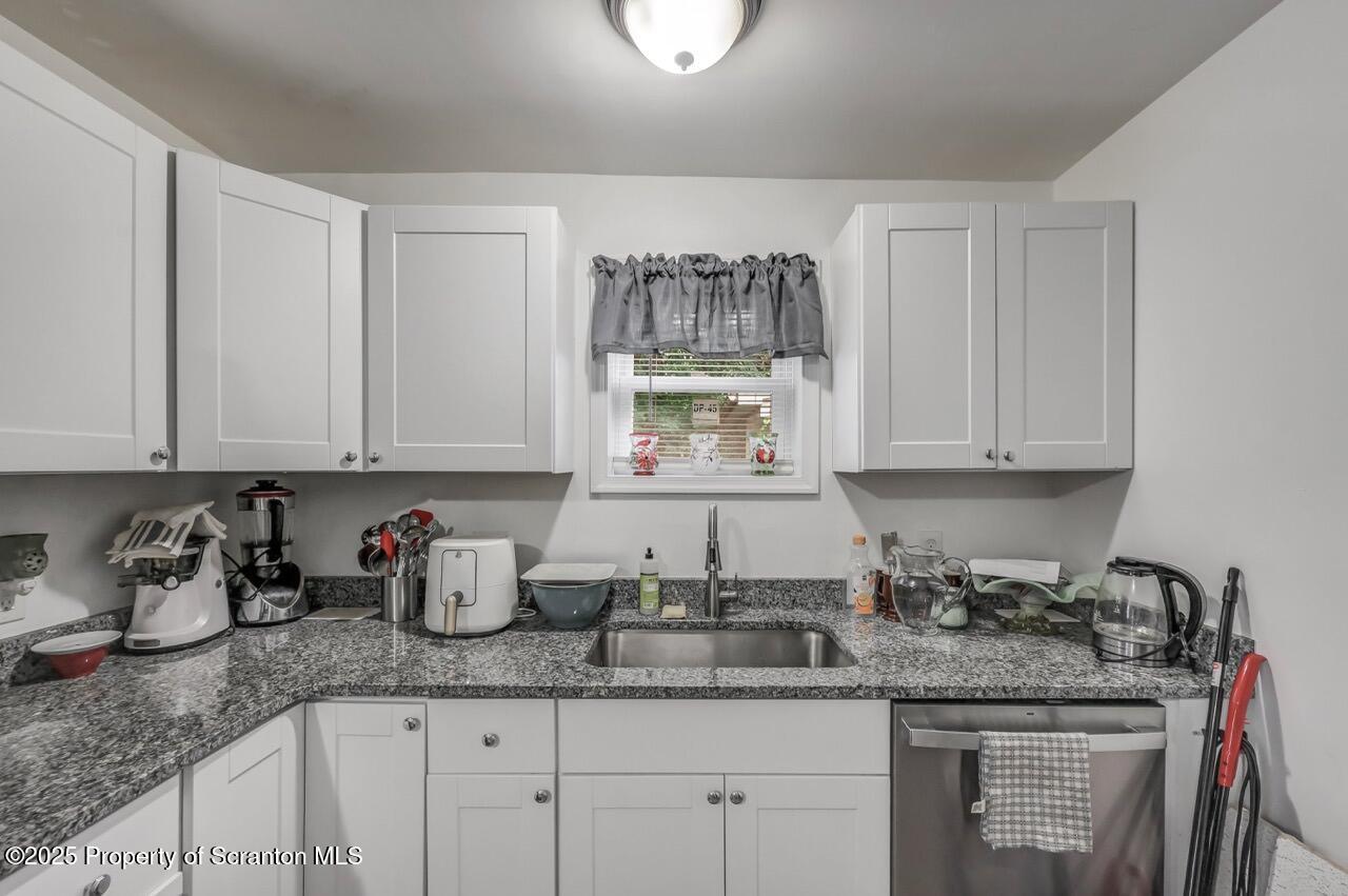 317-319 10th Avenue Scranton, PA 18504 - Photo 14 of 64 a kitchen with granite countertop a sink stainless steel appliances and cabinets