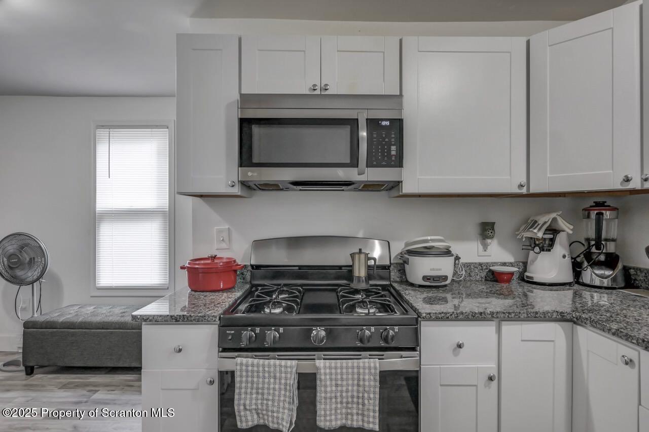 317-319 10th Avenue Scranton, PA 18504 - Photo 16 of 64 a kitchen with granite countertop a stove and a sink